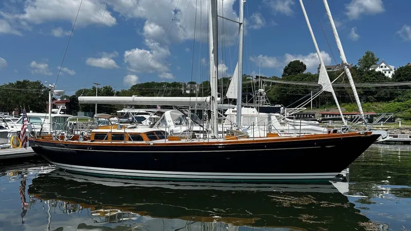 Slide: The Image of 2004 Lyman-Morse Sparkman & Stephens Sloop docked at marina under blue sky. - 2