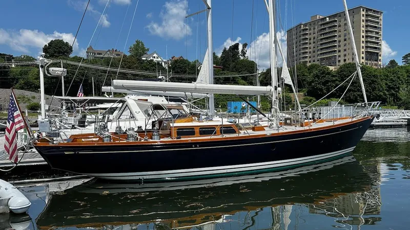 Slide: The Image of 2004 Lyman-Morse Sparkman & Stephens Sloop docked at marina with cityscape background. - 3