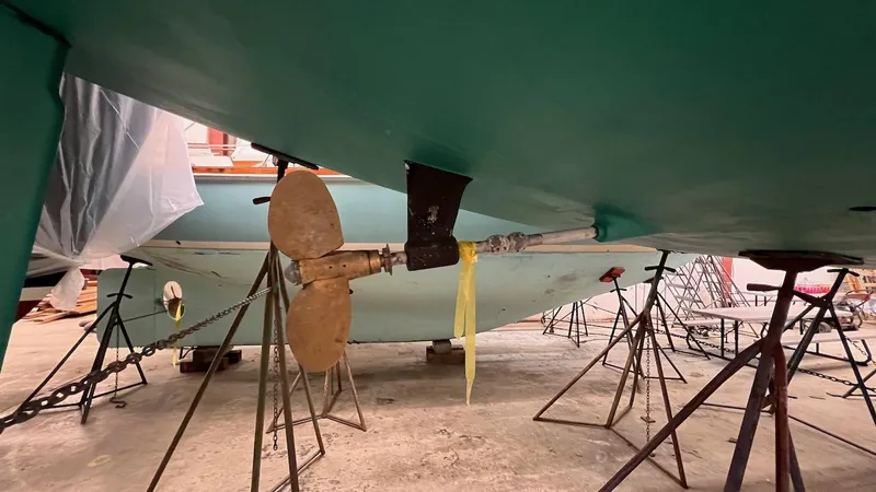 Slide: The Image of Lyman-Morse Sparkman & Stephens Sloop 2004 underbody with propeller and supports in dry dock. - 34