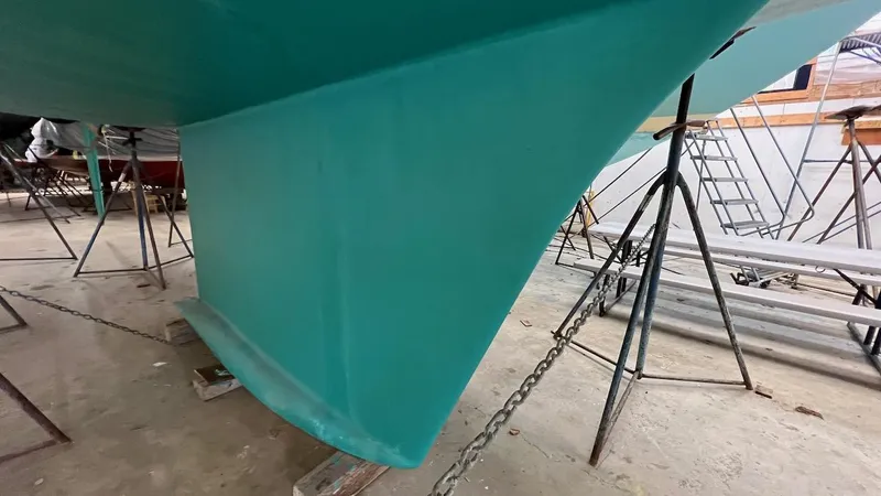 Slide: The Image of Close-up of the keel of a 2004 Lyman-Morse Sparkman & Stephens Sloop in a boatyard. - 38