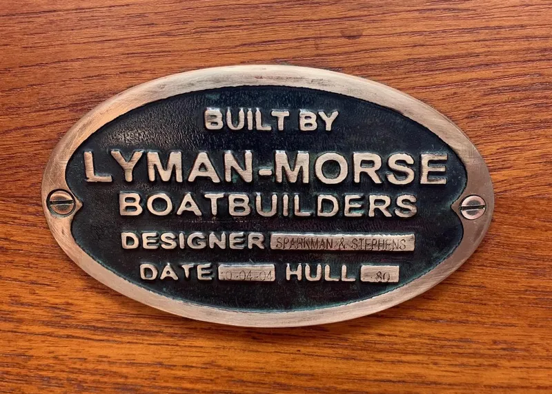 Slide: The Image of 2004 Lyman-Morse Sparkman & Stephens Sloop builder's plaque on wood background. - 45