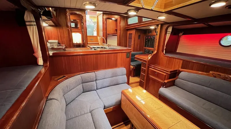 Slide: The Image of Luxurious interior of 2004 Lyman-Morse Sparkman & Stephens Sloop with wooden finishes and blue seating. - 48
