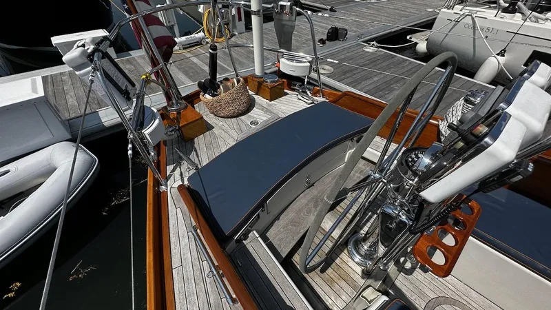 Slide: The Image of 2004 Lyman-Morse Sparkman & Stephens Sloop cockpit with steering wheel and deck details. - 9