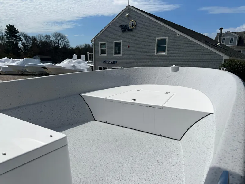 Slide: The Image of 2024 Maritime 2090 Skiff boat interior with storage compartment, docked near a building. - 10