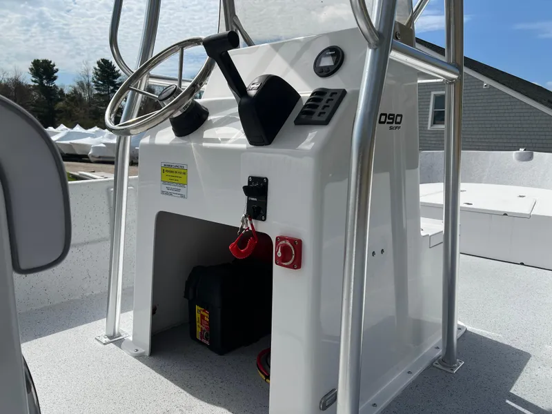 Slide: The Image of 2024 Maritime 2090 Skiff boat console with steering wheel and controls. - 11