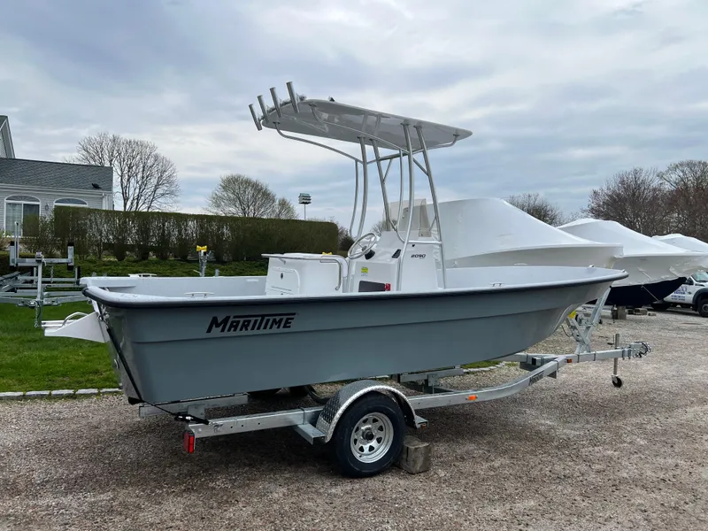 Slide: The Image of 2024 Maritime 2090 Skiff boat on a trailer, parked outdoors. - 14