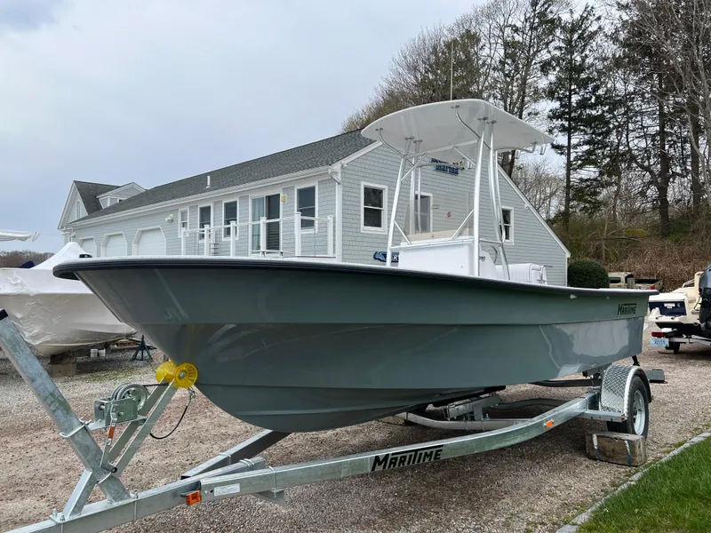Slide: The Image of 2024 Maritime 2090 Skiff boat on trailer in front of house. - 15