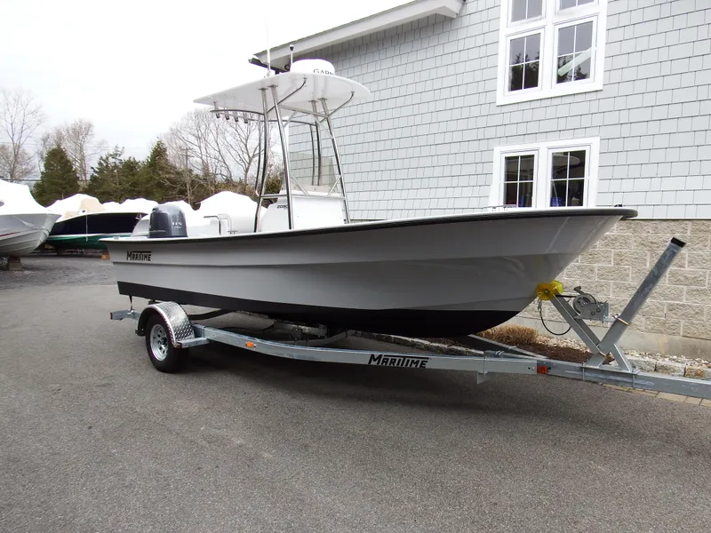 Slide: The Image of 2024 Maritime 2090 Skiff boat on trailer outside a building. - 20