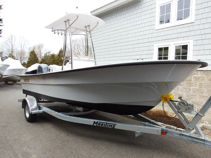 Slide: The Image of 2024 Maritime 2090 Skiff boat on trailer outside a building. - 21