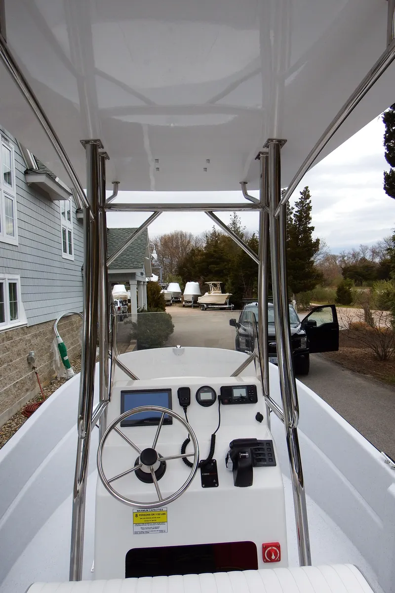 Slide: The Image of 2024 Maritime 2090 Skiff boat console with steering wheel and navigation equipment. - 24