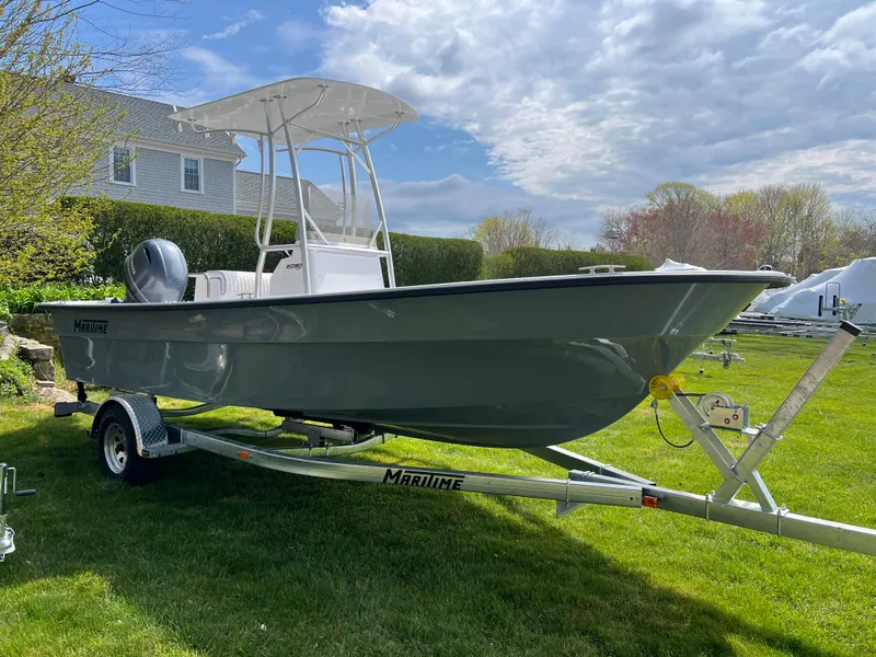 Slide: The Image of 2024 Maritime 2090 Skiff boat on trailer in a grassy yard. - 3