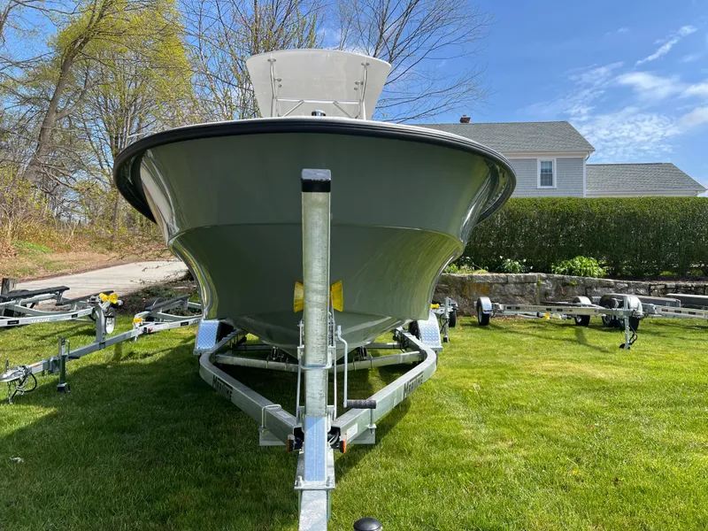 Slide: The Image of 2024 Maritime 2090 Skiff boat on trailer, parked on grass with house in background. - 4