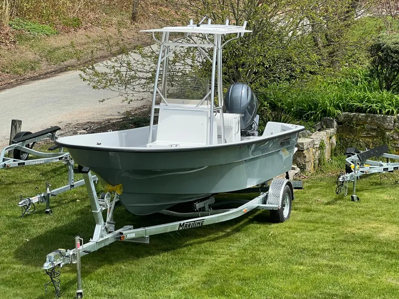 Slide: The Image of 2024 Maritime 2090 Skiff boat on a trailer, parked on a grassy lawn. - 5