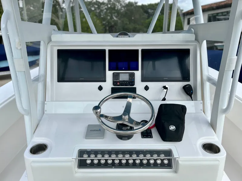 Slide: The Image of 2023 Invincible 36' Open Fisherman boat dashboard with dual screens and steering wheel. - 2