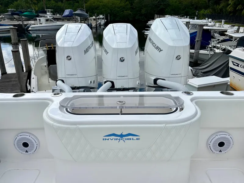 Slide: The Image of 2023 Invincible 36' Open Fisherman with triple Mercury engines at a marina. - 23
