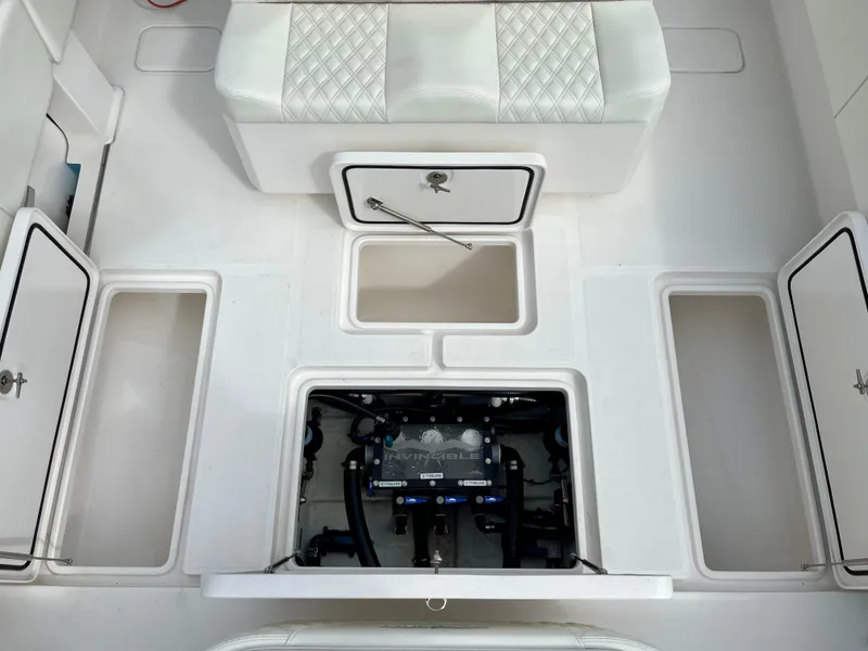 Slide: The Image of 2023 Invincible 36' Open Fisherman boat interior with storage compartments and engine access. - 25