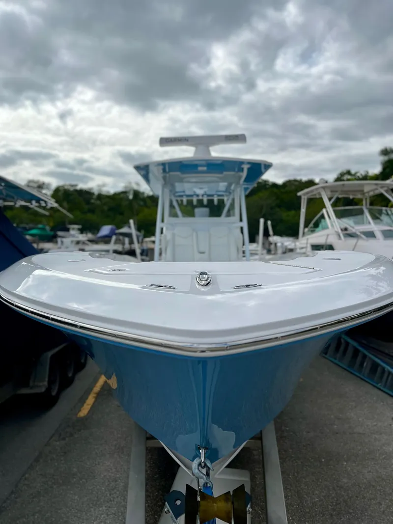 Slide: The Image of 2023 Invincible 36' Open Fisherman boat, front view, docked under cloudy sky. - 37