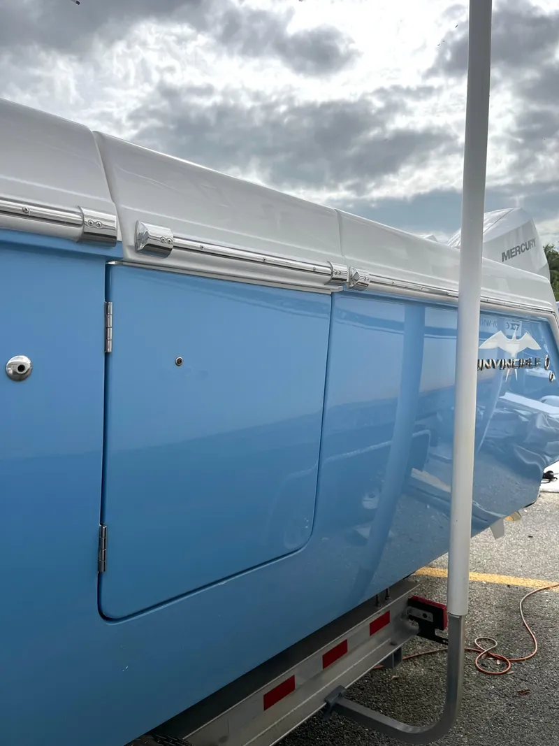 Slide: The Image of 2023 Invincible 36' Open Fisherman boat in blue on a trailer. - 39