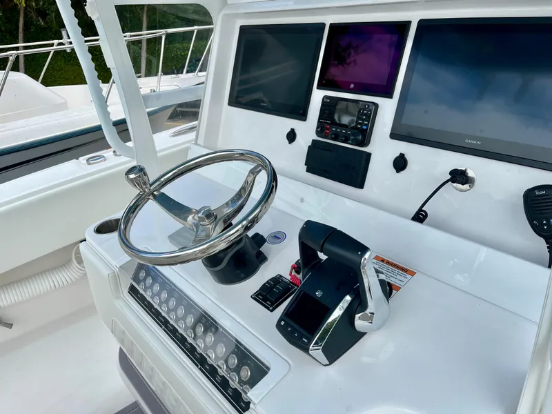 Slide: The Image of Control console of 2023 Invincible 36' Open Fisherman boat with steering wheel and electronic displays. - 4