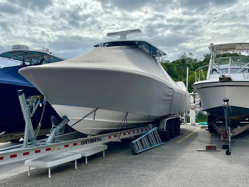 Slide: The Image of 2023 Invincible 36' Open Fisherman boat covered on a trailer in a marina. - 40