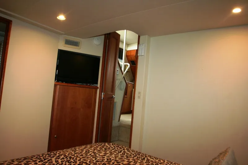 Slide: The Image of Interior of 2000 Silverton 392 Motor Yacht bedroom with TV and leopard print bedding. - 14