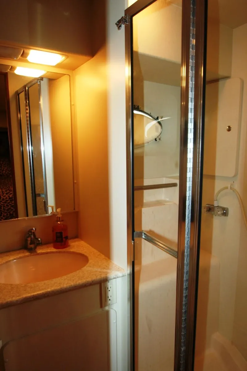 Slide: The Image of 2000 Silverton 392 Motor Yacht bathroom with sink and shower. - 17