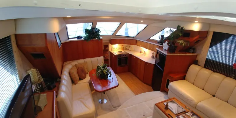 Slide: The Image of Luxurious interior of a 2000 Silverton 392 Motor Yacht with modern kitchen and cozy seating area. - 2