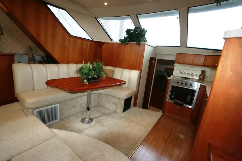 Slide: The Image of 2000 Silverton 392 Motor Yacht interior with dining area and kitchen. - 21