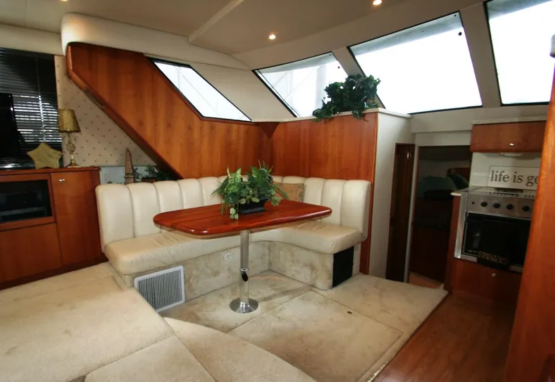 Slide: The Image of Interior of a 2000 Silverton 392 Motor Yacht with dining area and kitchen. - 22