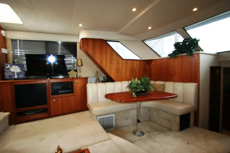 Slide: The Image of Interior of 2000 Silverton 392 Motor Yacht with seating area and entertainment center. - 23