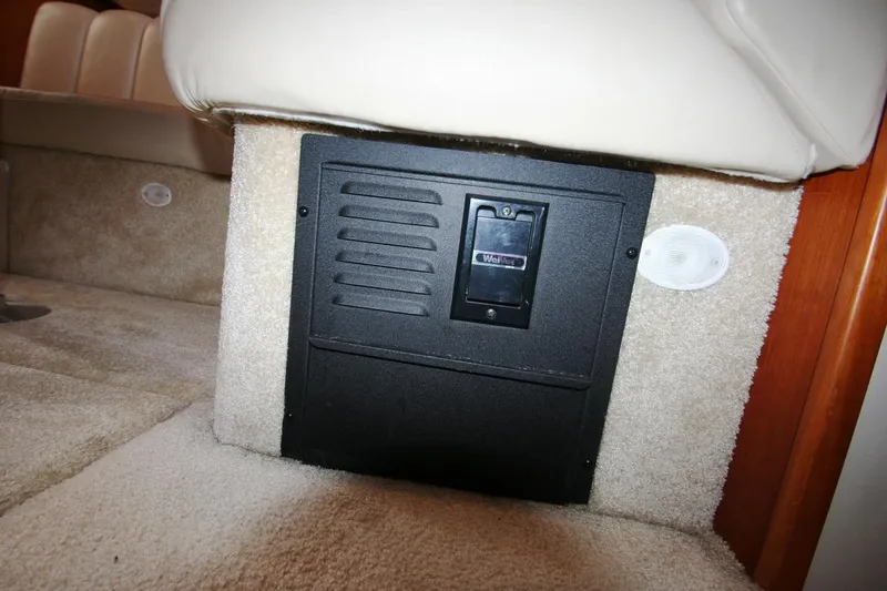Slide: The Image of 2000 Silverton 392 Motor Yacht interior, showing a black vent panel on beige carpet. - 24