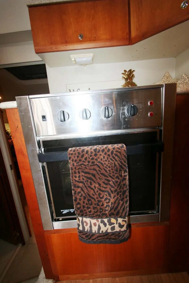 Slide: The Image of Stainless steel oven in 2000 Silverton 392 Motor Yacht kitchen with leopard print towel. - 25
