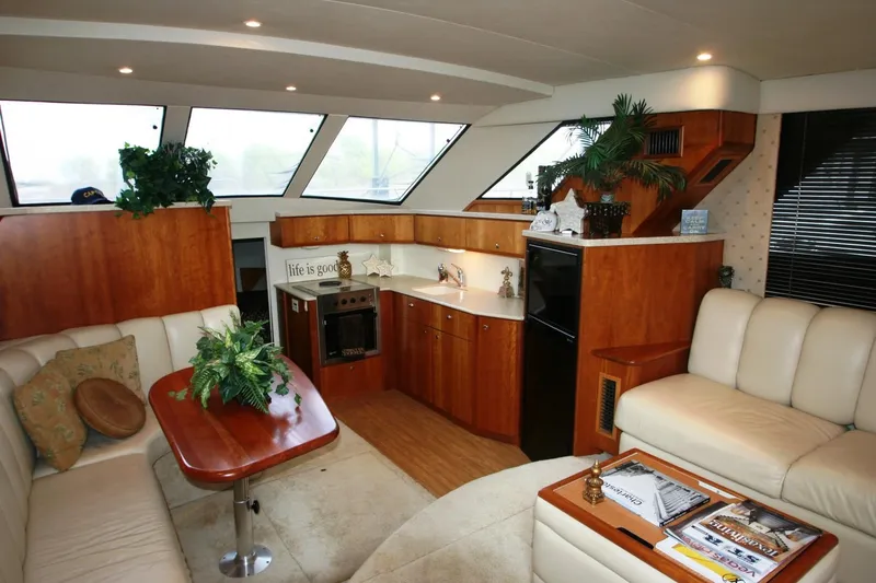 Slide: The Image of Interior of a 2000 Silverton 392 Motor Yacht with modern kitchen and seating area. - 30