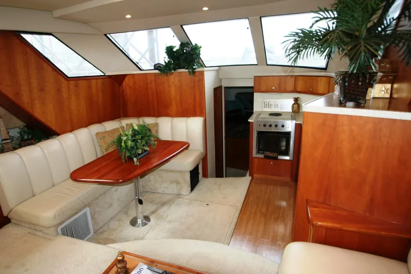 Slide: The Image of 2000 Silverton 392 Motor Yacht interior with dining area and kitchenette. - 31