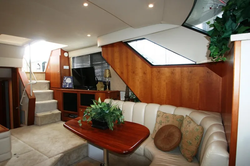 Slide: The Image of Interior of 2000 Silverton 392 Motor Yacht with plush seating and wooden accents. - 32