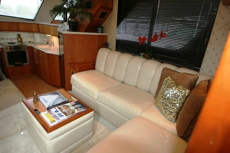 Slide: The Image of Interior of 2000 Silverton 392 Motor Yacht with beige leather sofa and wooden cabinetry. - 40