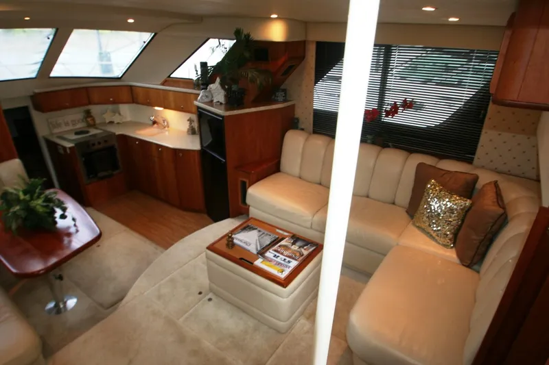Slide: The Image of Interior of 2000 Silverton 392 Motor Yacht with luxurious seating and modern kitchen. - 49