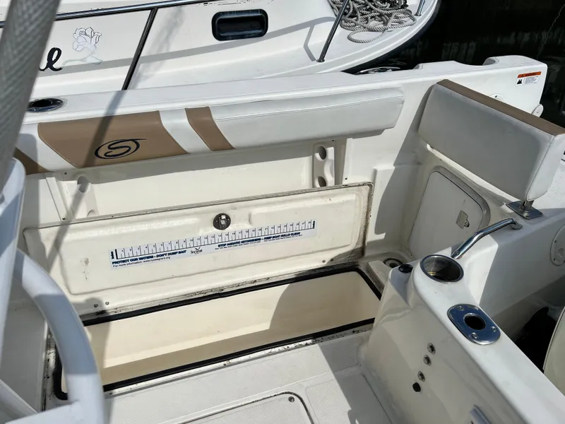 Slide: The Image of 2014 Striper 220 Center Console boat interior with open storage compartment. - 14