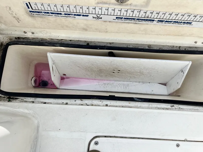 Slide: The Image of Livewell compartment on a 2014 Striper 220 Center Console boat with measurement guide. - 18