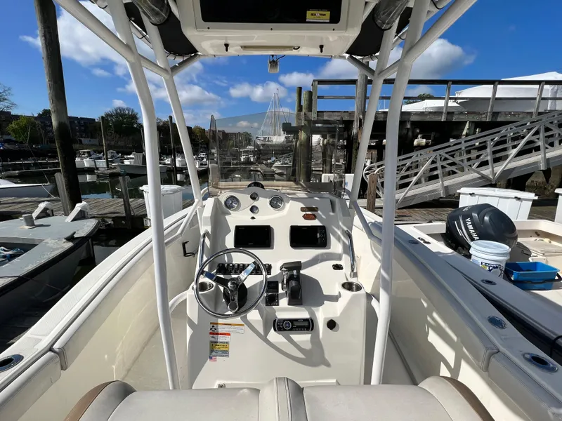 Slide: The Image of 2014 Striper 220 Center Console boat docked at marina under blue sky. - 20
