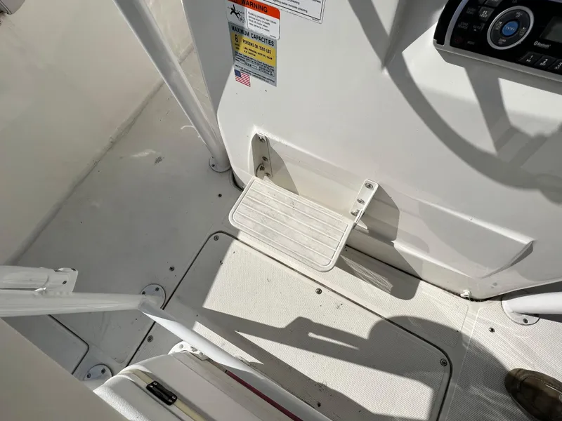 Slide: The Image of 2014 Striper 220 Center Console boat interior with step and control panel. - 22