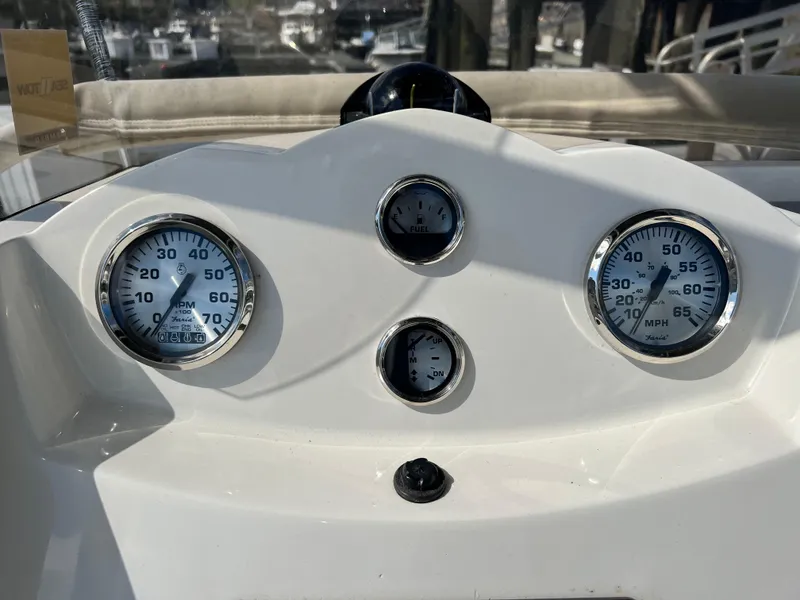 Slide: The Image of Dashboard of a 2014 Striper 220 Center Console boat with gauges and controls. - 23