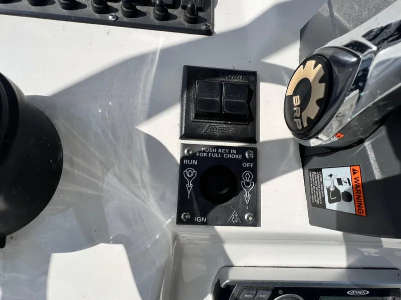 Slide: The Image of Control panel of a 2014 Striper 220 Center Console boat with ignition and warning labels. - 25