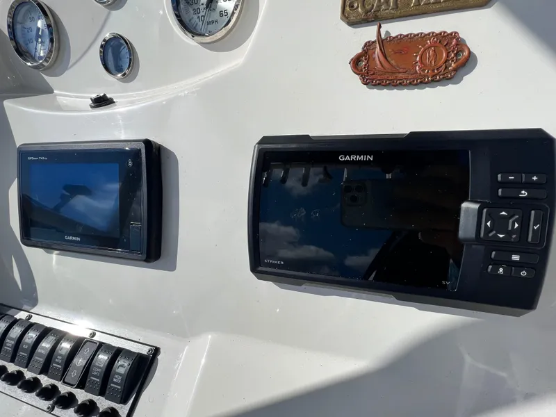 Slide: The Image of 2014 Striper 220 Center Console dashboard with Garmin navigation displays and gauges. - 28