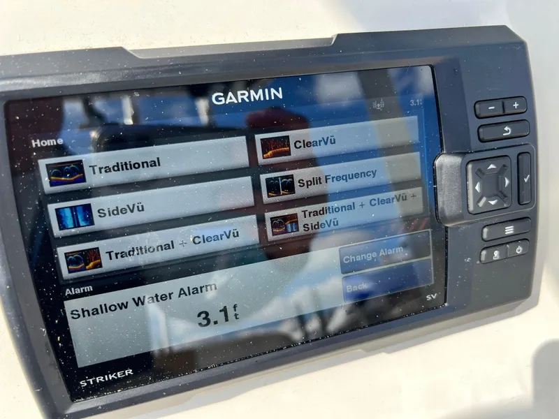 Slide: The Image of Garmin fishfinder display on 2014 Striper 220 Center Console, showing sonar options and shallow water alarm. - 33