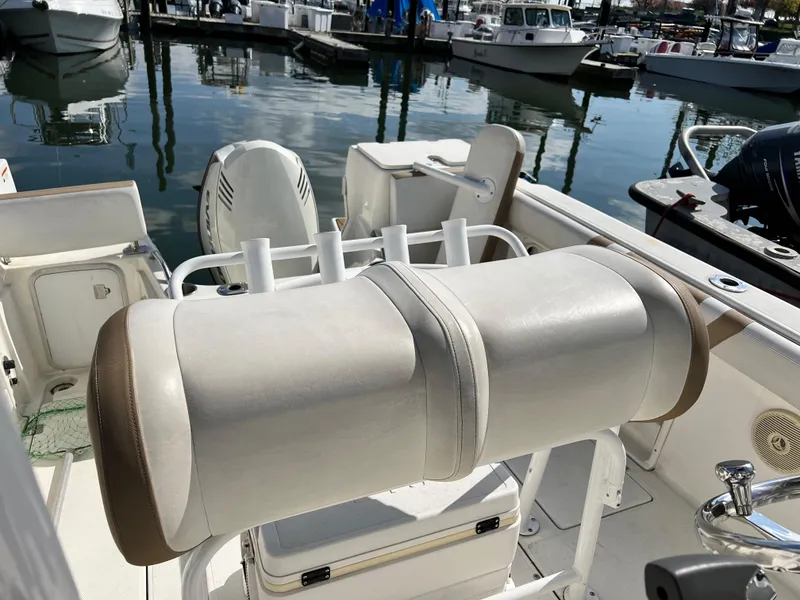 Slide: The Image of 2014 Striper 220 Center Console boat interior with seating and fishing rod holders. - 36