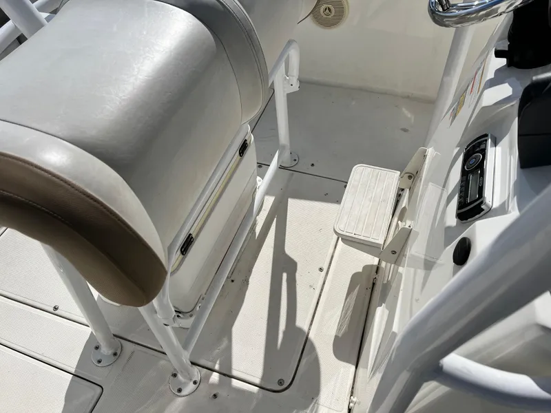 Slide: The Image of 2014 Striper 220 Center Console boat interior with seating and control panel. - 37