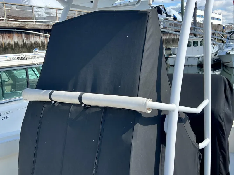 Slide: The Image of 2014 Striper 220 Center Console boat with black cover at marina. - 4