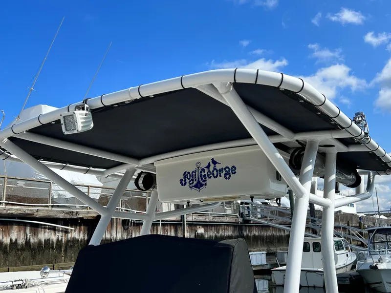 Slide: The Image of 2014 Striper 220 Center Console boat with custom canopy at marina. - 42