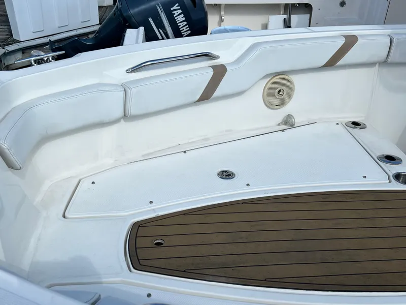 Slide: The Image of 2014 Striper 220 Center Console boat interior with Yamaha engine, featuring cushioned seating and deck. - 43